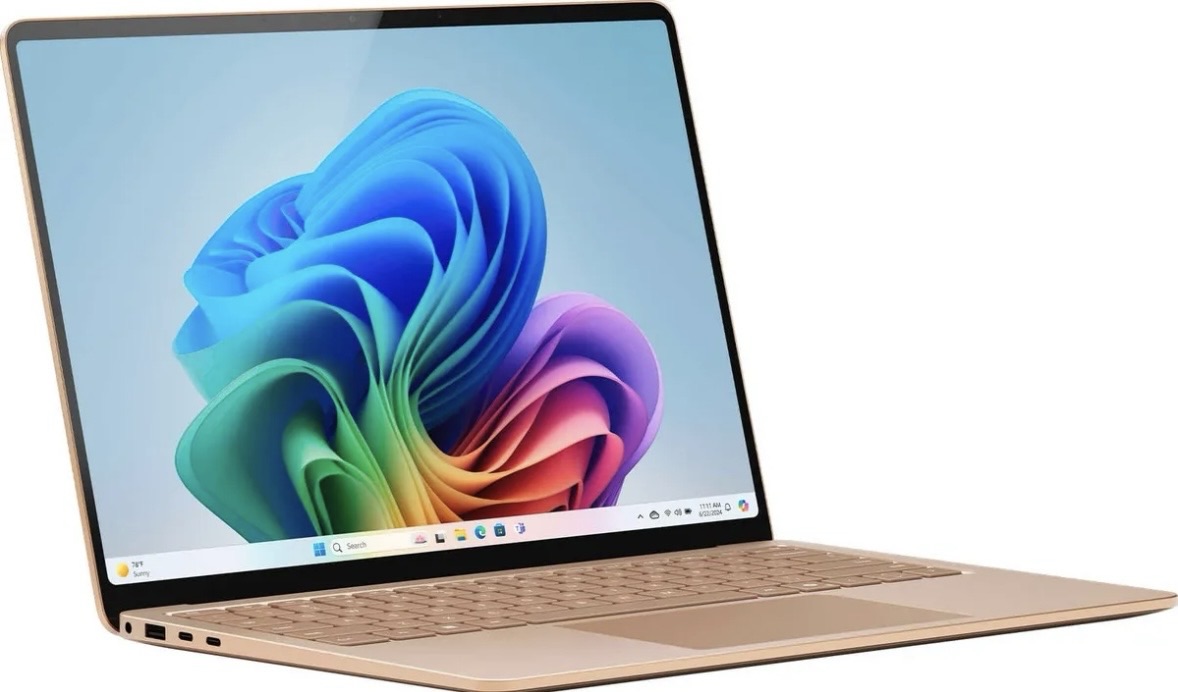 Laptop moderna de color dorado con pantalla colorida y teclado en la parte inferior.